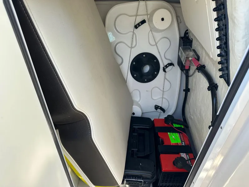 Slide: The Image of Storage compartment of 2023 Sailfish 245 DC boat with battery and seat cushion. - 43