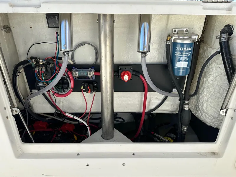 Slide: The Image of 2023 Sailfish 245 DC boat engine compartment with wiring and Yamaha fuel filter. - 45