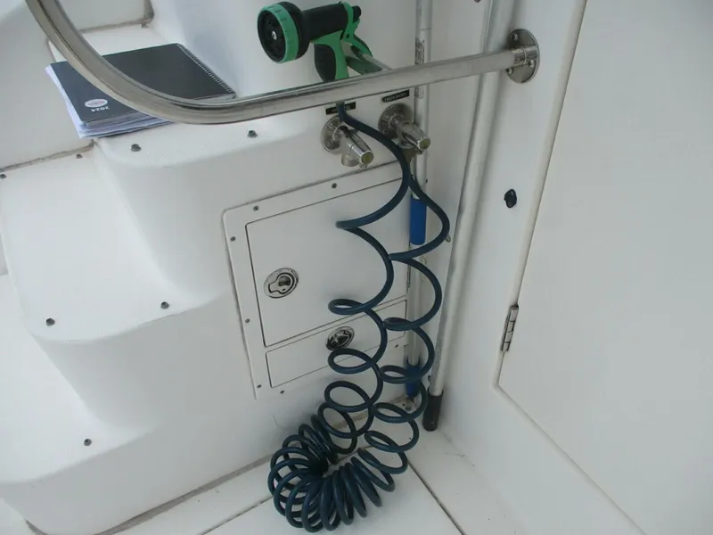 Slide: The Image of 2007 Silverton 33 Convertible boat deck with coiled hose and railing. - 14