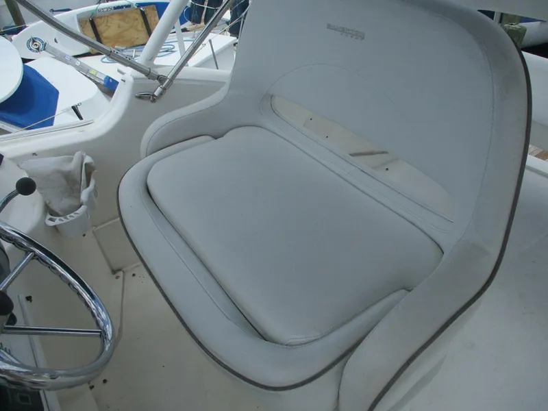 Slide: The Image of 2007 Silverton 33 Convertible boat helm seat with steering wheel. - 26