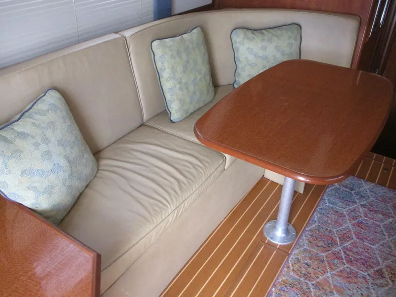 Slide: The Image of Interior of 2007 Silverton 33 Convertible with beige sofa and wooden table. - 38