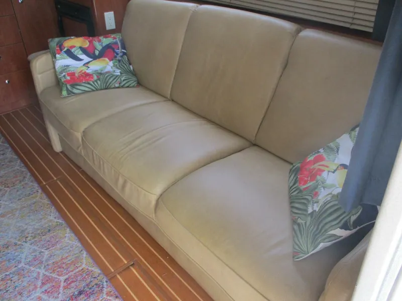 Slide: The Image of Beige sofa with floral cushions inside a 2007 Silverton 33 Convertible boat. - 39