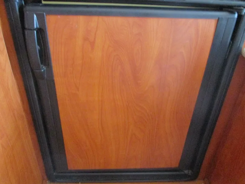 Slide: The Image of Wooden cabinet door on 2007 Silverton 33 Convertible boat interior. - 40