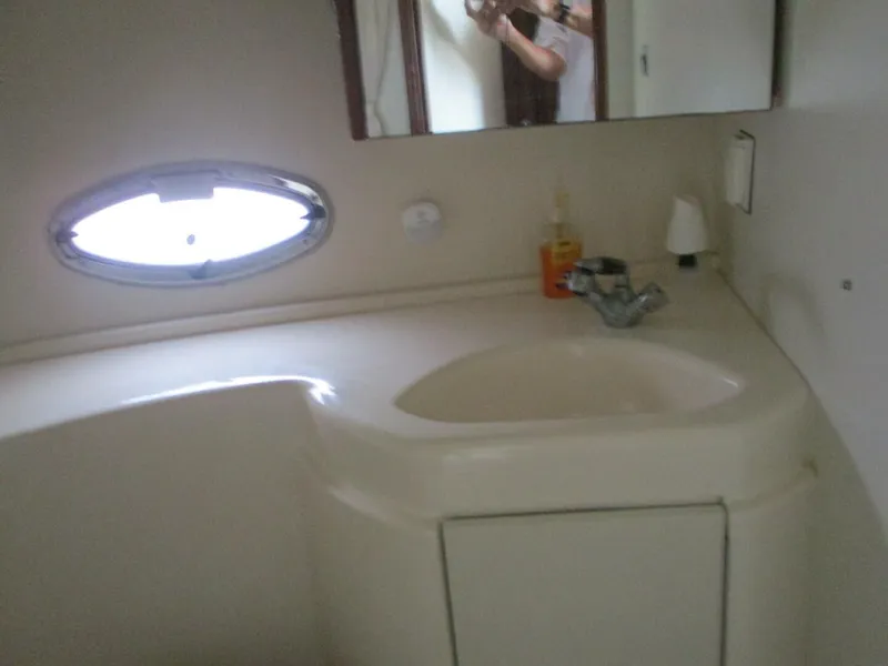 Slide: The Image of 2007 Silverton 33 Convertible yacht bathroom with sink and oval window. - 46