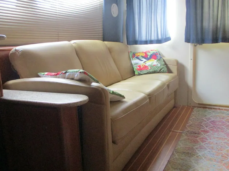 Slide: The Image of Interior of 2007 Silverton 33 Convertible with beige sofa and colorful cushions. - 47