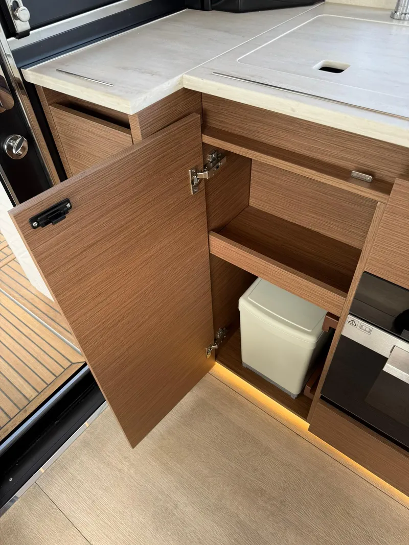 Slide: The Image of 2025 Wellcraft 44 Explorer yacht interior with open wooden cabinet and modern design. - 12