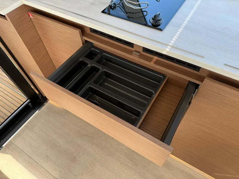 Slide: The Image of Open drawer with utensil organizer in Wellcraft 44 Explorer, 2025 model yacht interior. - 14