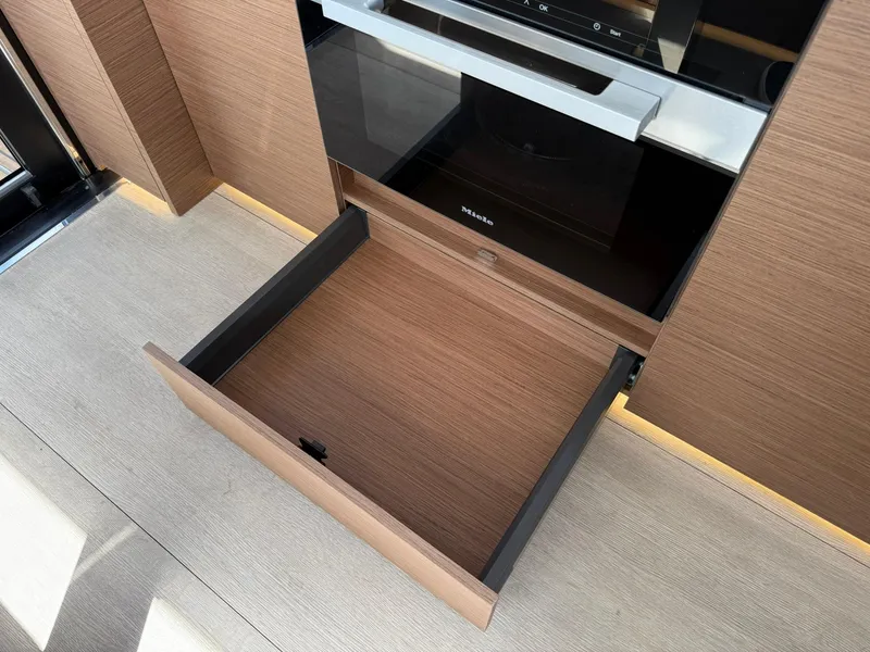 Slide: The Image of Open drawer in 2025 Wellcraft 44 Explorer yacht interior, showcasing modern wood finish. - 16
