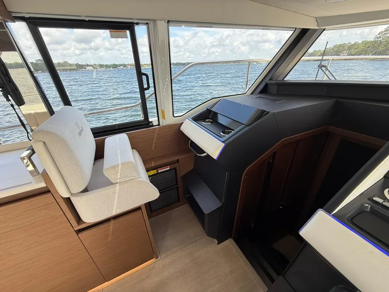 Slide: The Image of 2025 Wellcraft 44 Explorer helm with modern controls, overlooking serene waters. - 19