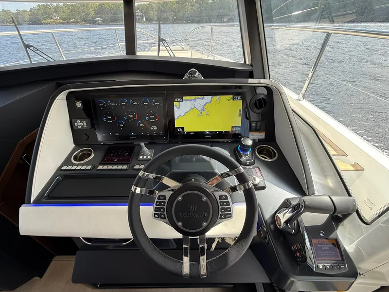 Slide: The Image of 2025 Wellcraft 44 Explorer helm with advanced navigation and control systems. - 26