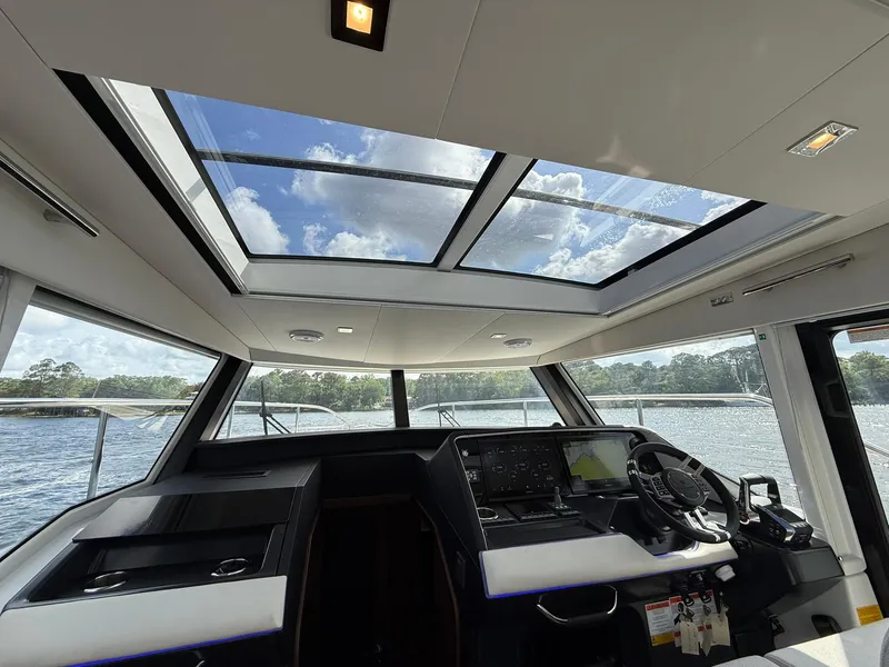 Slide: The Image of 2025 Wellcraft 44 Explorer yacht interior with panoramic sunroof and modern helm controls. - 31