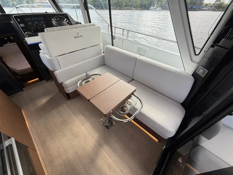 Slide: The Image of Interior of 2025 Wellcraft 44 Explorer yacht with modern seating and table. - 34