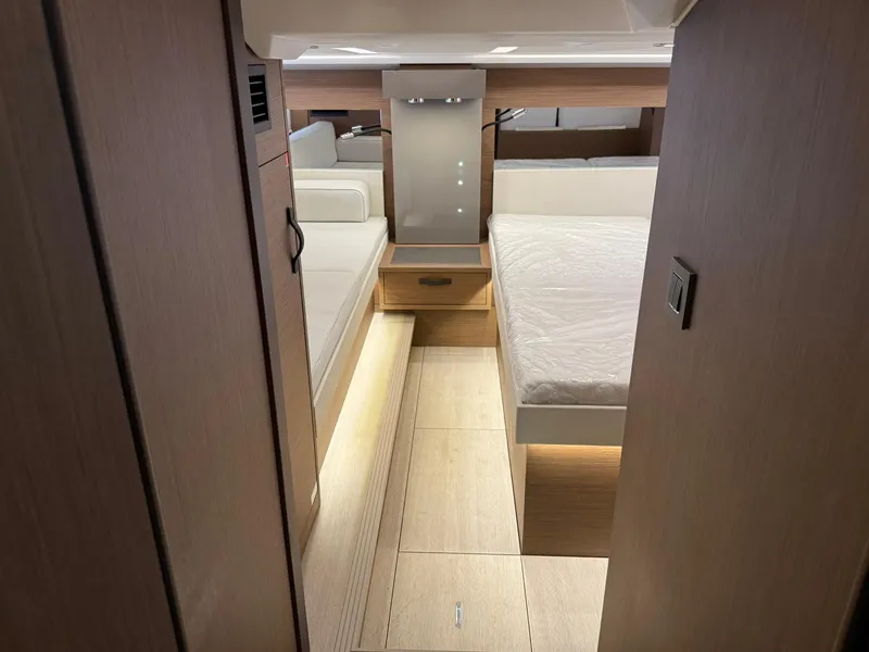 Slide: The Image of Interior of 2025 Wellcraft 44 Explorer yacht, featuring modern wood finishes and cozy sleeping area. - 41