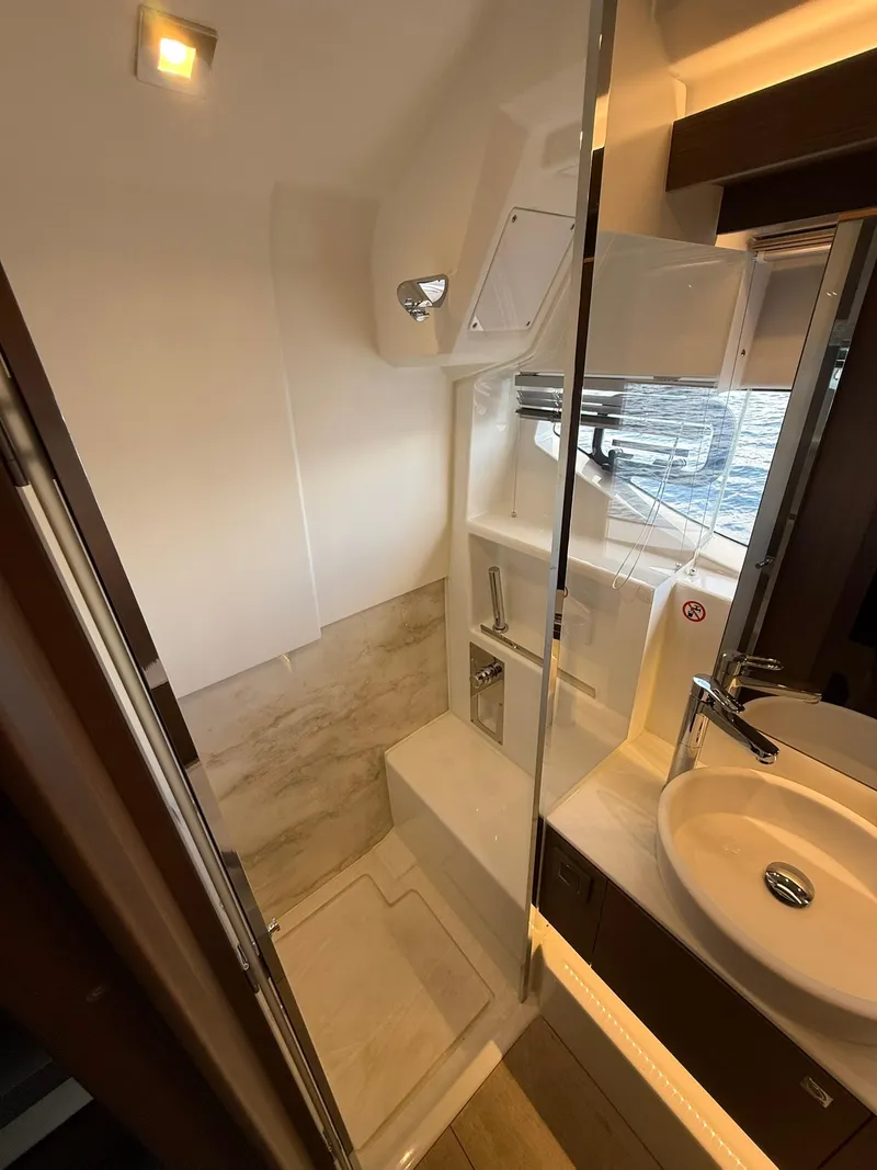 Slide: The Image of Modern bathroom in 2025 Wellcraft 44 Explorer yacht with sleek fixtures and natural lighting. - 48