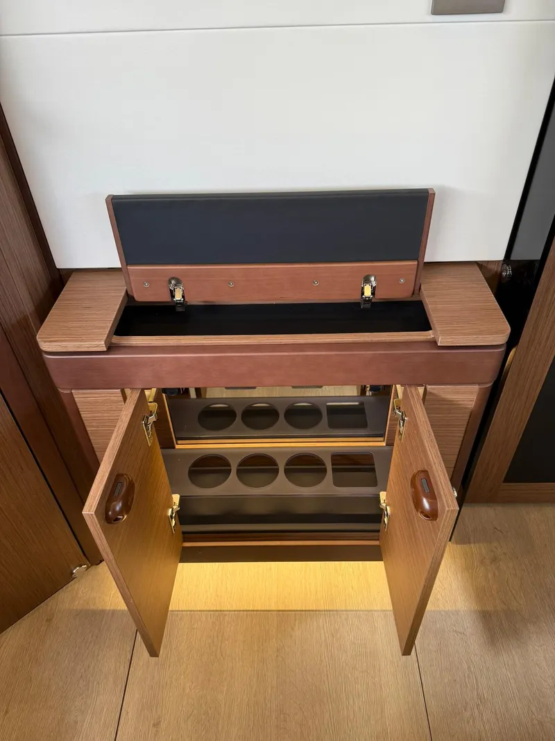 Slide: The Image of 2025 Wellcraft 44 Explorer interior cabinet with open doors and storage compartments. - 52