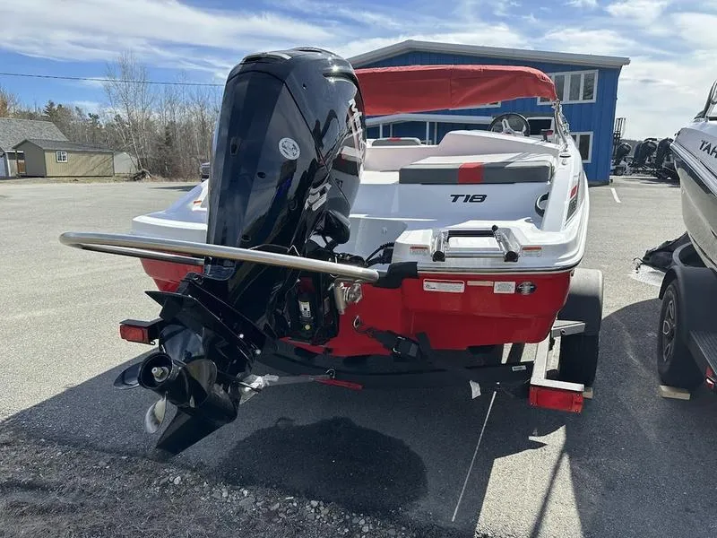 Slide: The Image of 2025 Tahoe T18 boat with outboard motor, red and white design, parked on a trailer. - 3