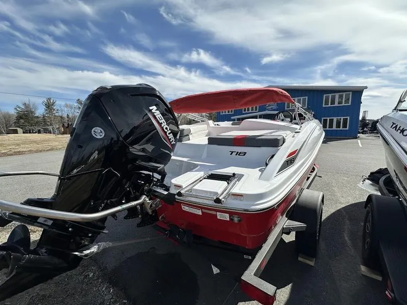 Slide: The Image of 2025 Tahoe T18 boat with Mercury engine on trailer, parked outdoors. - 4