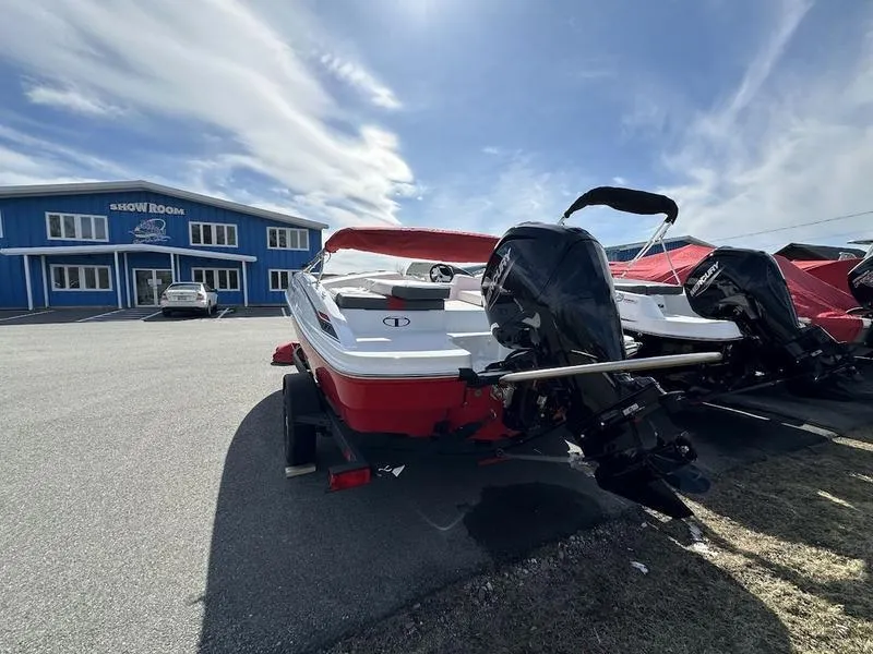 Slide: The Image of 2025 Tahoe T18 boat parked outside a showroom under a clear sky. - 5