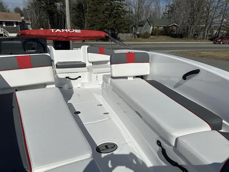 Slide: The Image of 2025 Tahoe T18 boat interior with white and red seating, outdoor setting. - 7