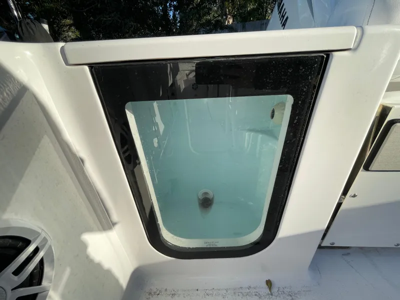 Slide: The Image of 2024 Sportsman Open 232 Center Console livewell with clear lid. - 10