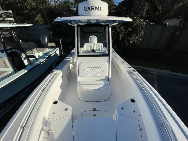 Slide: The Image of 2024 Sportsman Open 232 Center Console boat with Garmin equipment, sleek design, and spacious seating. - 4