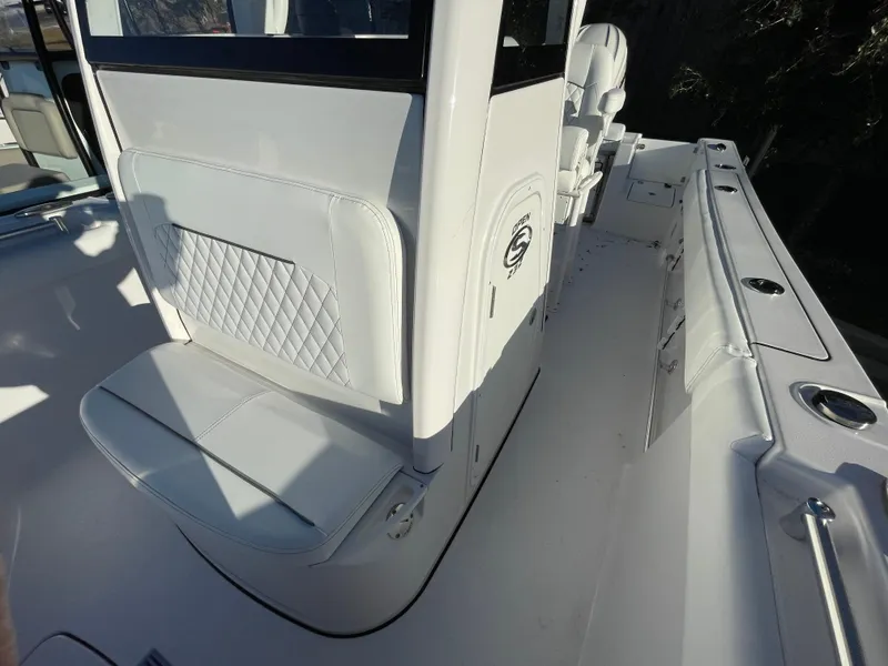 Slide: The Image of 2024 Sportsman Open 232 Center Console boat interior with seating and console details. - 6