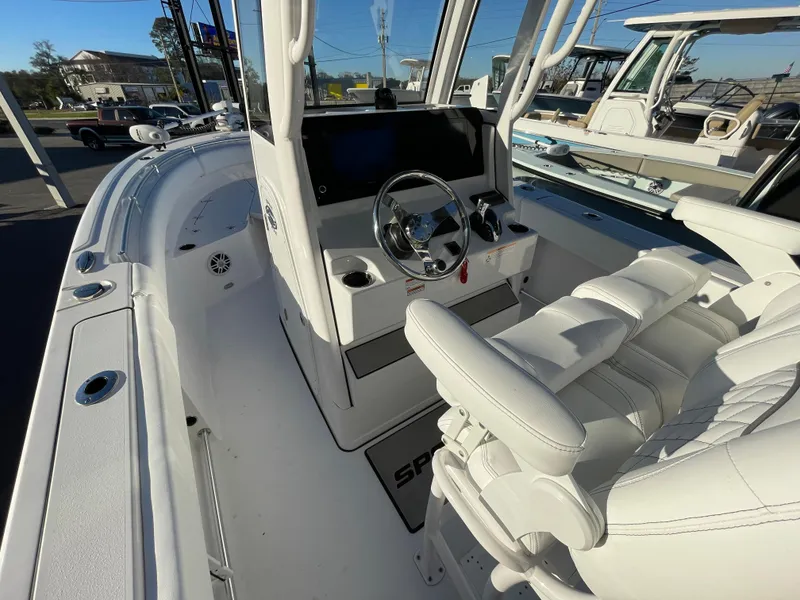 Slide: The Image of 2024 Sportsman Open 232 Center Console boat interior with steering wheel and seating. - 7