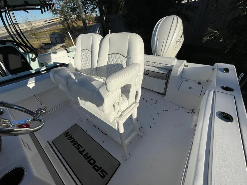 Slide: The Image of 2024 Sportsman Open 232 Center Console boat interior with white seating and steering wheel. - 8