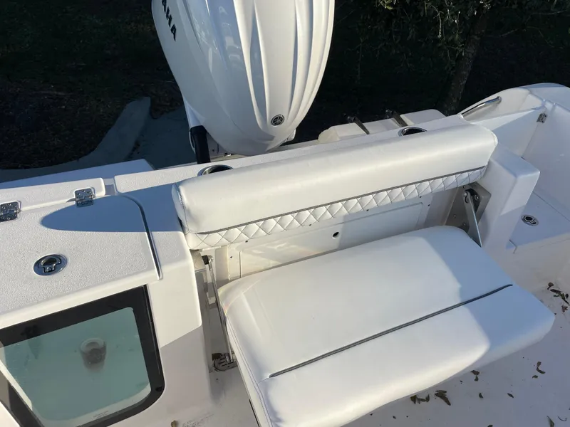 Slide: The Image of 2024 Sportsman Open 232 Center Console boat with white seating and Yamaha engine. - 9