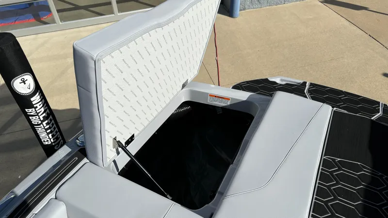 Slide: The Image of 2025 MasterCraft NXT24 boat storage compartment with open lid, showcasing interior space. - 20