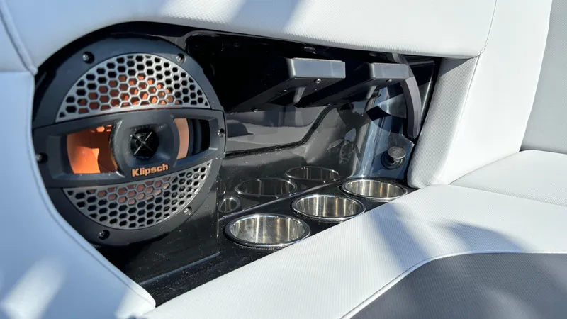 Slide: The Image of 2025 MasterCraft NXT24 interior with Klipsch speaker and cup holders. - 24