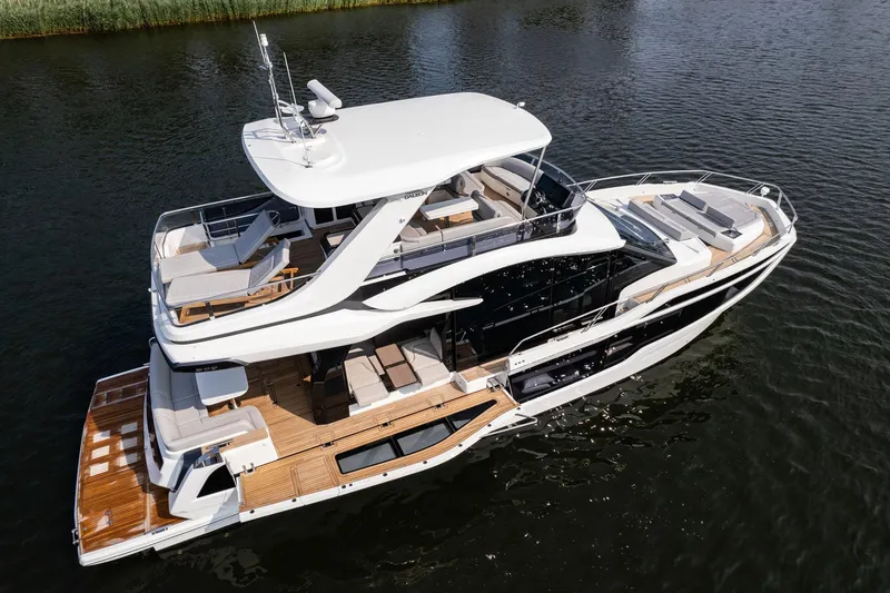Slide: The Image of 2025 Galeon 560 Fly yacht on calm water, showcasing luxury design and spacious decks. - 3
