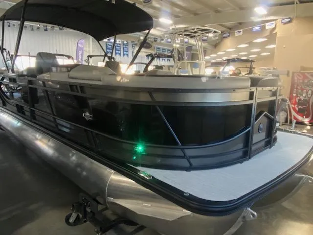 Slide: The Image of 2025 South Bay 500 pontoon boat displayed indoors. - 2