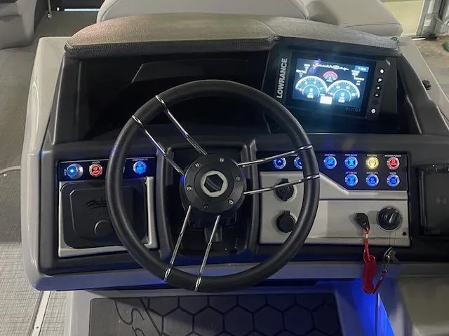 Slide: The Image of South Bay 500 boat dashboard with steering wheel and digital display, 2025 model. - 8