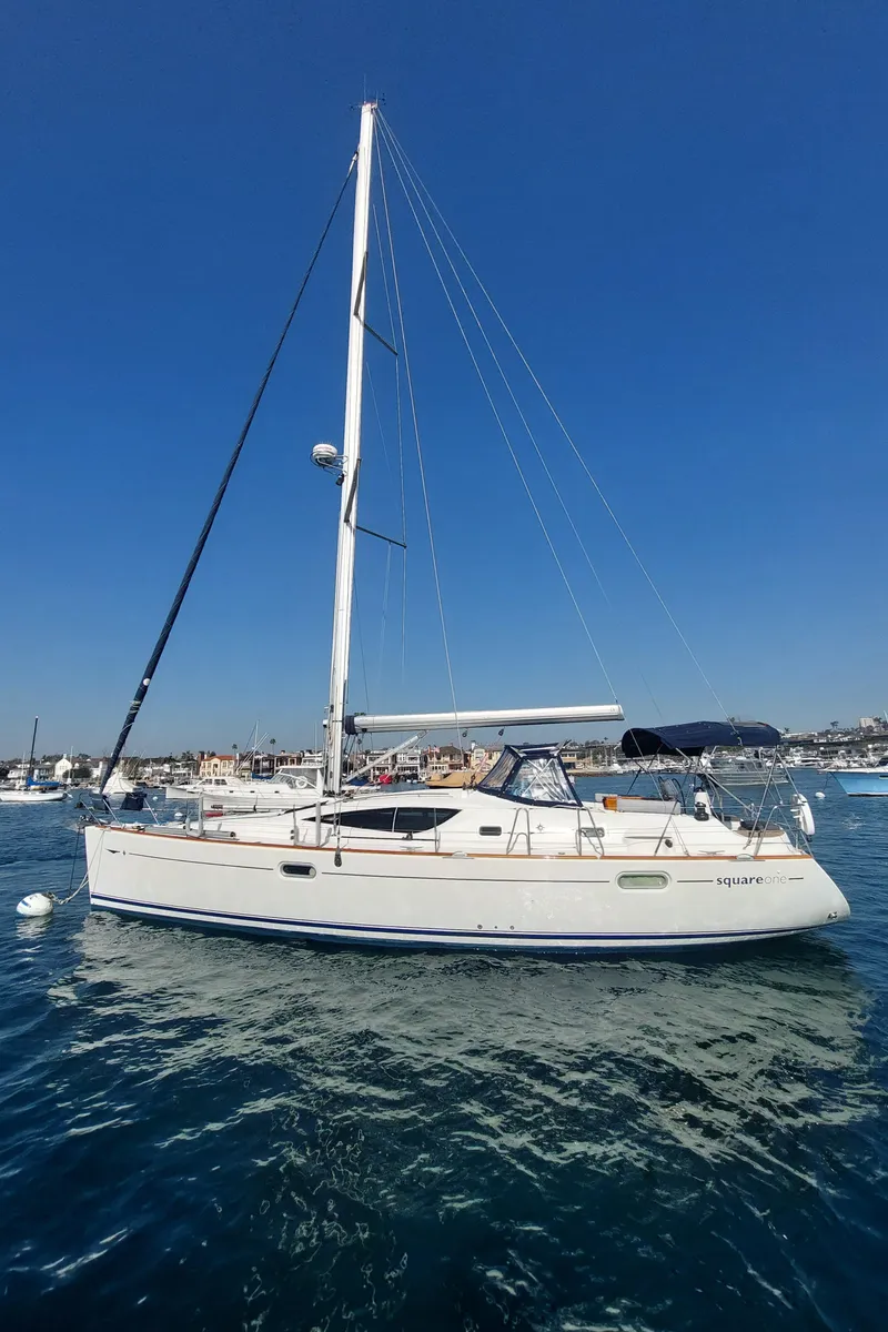 Slide: The Image of 2006 Jeanneau Sun Odyssey 42 DS sailboat on calm water under clear blue sky. - 0