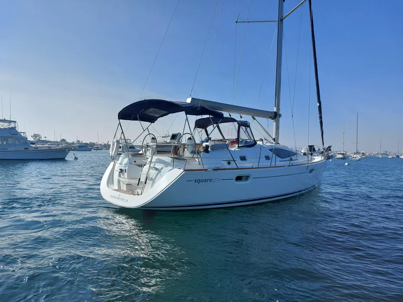 Slide: The Image of 2006 Jeanneau Sun Odyssey 42 DS sailboat on calm water, clear sky background. - 1