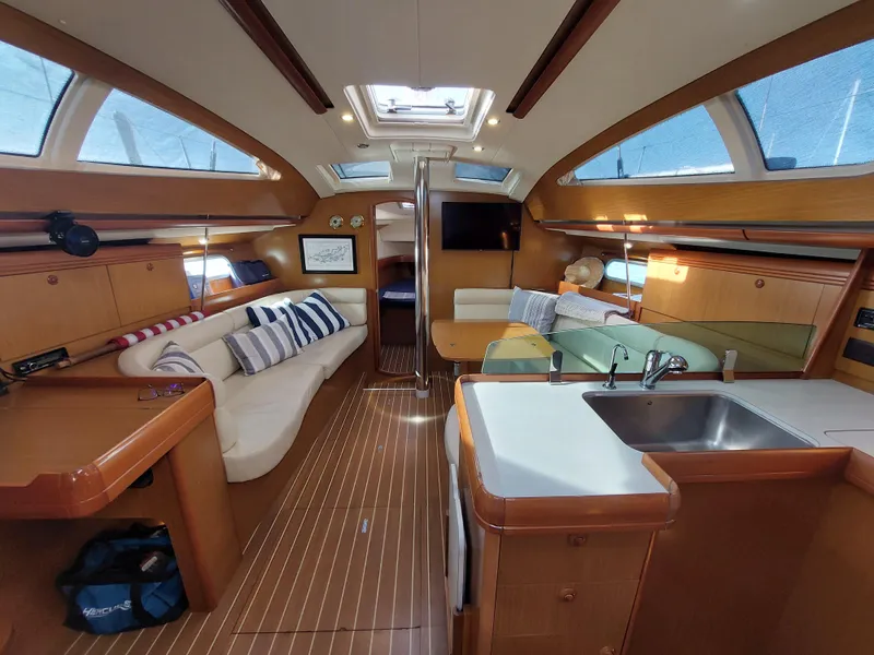 Slide: The Image of Interior of 2006 Jeanneau Sun Odyssey 42 DS sailboat, featuring cozy seating and modern kitchen. - 13