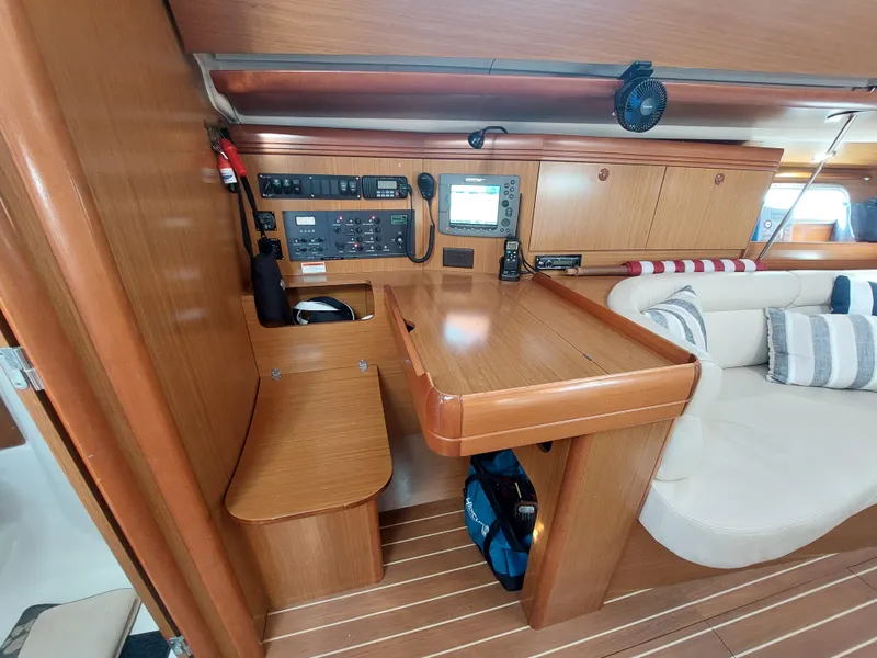 Slide: The Image of Interior of 2006 Jeanneau Sun Odyssey 42 DS, featuring navigation station and seating area. - 14