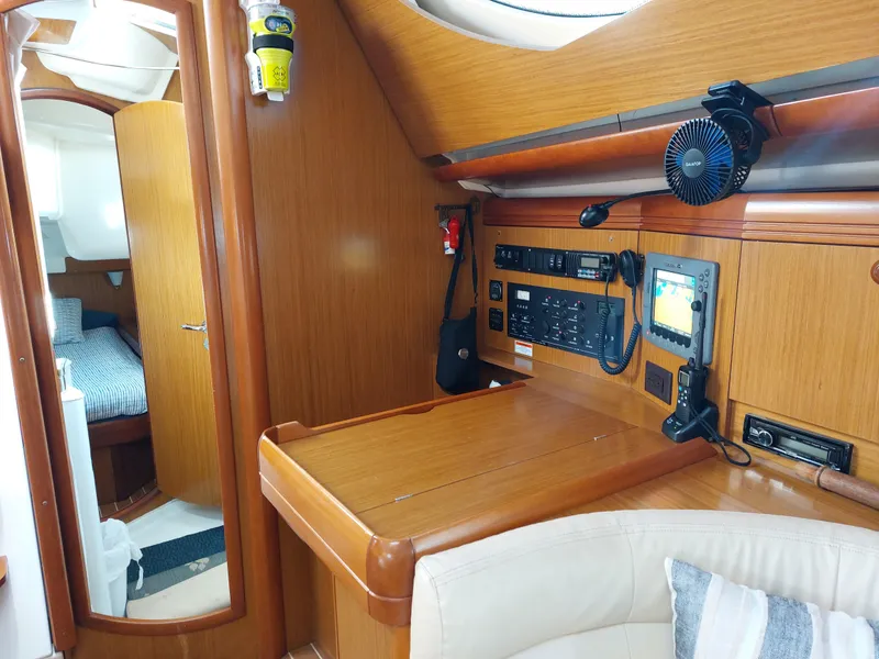 Slide: The Image of Interior of 2006 Jeanneau Sun Odyssey 42 DS, featuring navigation station and cozy cabin. - 16