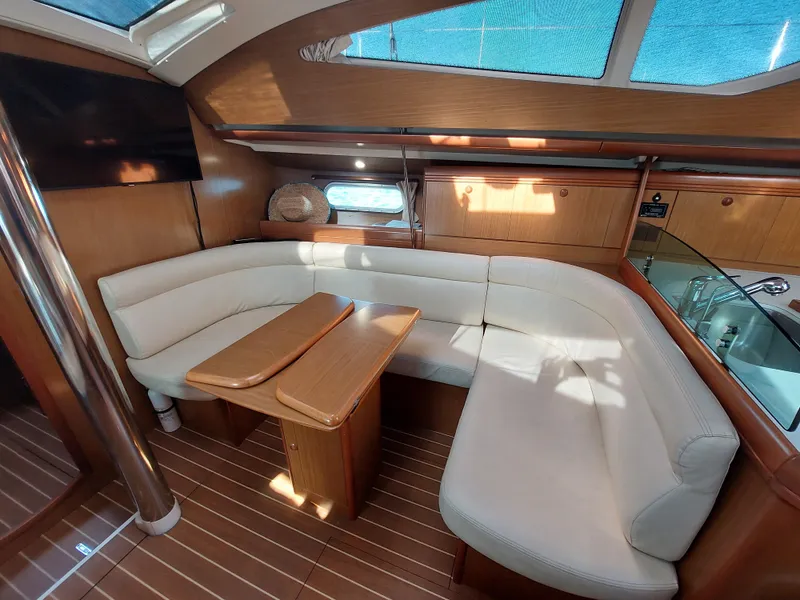 Slide: The Image of Interior of 2006 Jeanneau Sun Odyssey 42 DS yacht with elegant seating and wooden finishes. - 18