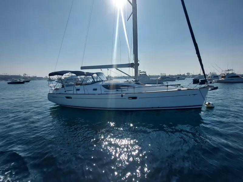 Slide: The Image of 2006 Jeanneau Sun Odyssey 42 DS sailboat on calm water, under bright sunlight. - 2