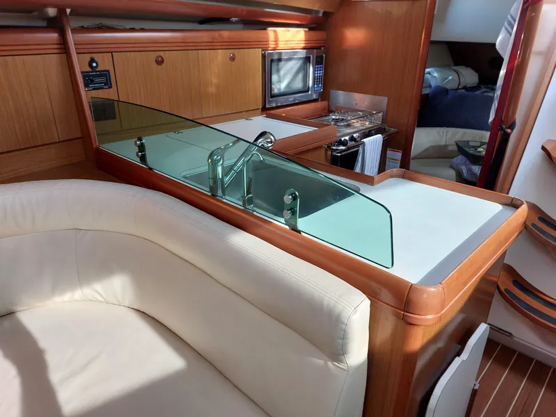 Slide: The Image of Interior of 2006 Jeanneau Sun Odyssey 42 DS yacht with modern kitchen and seating area. - 22