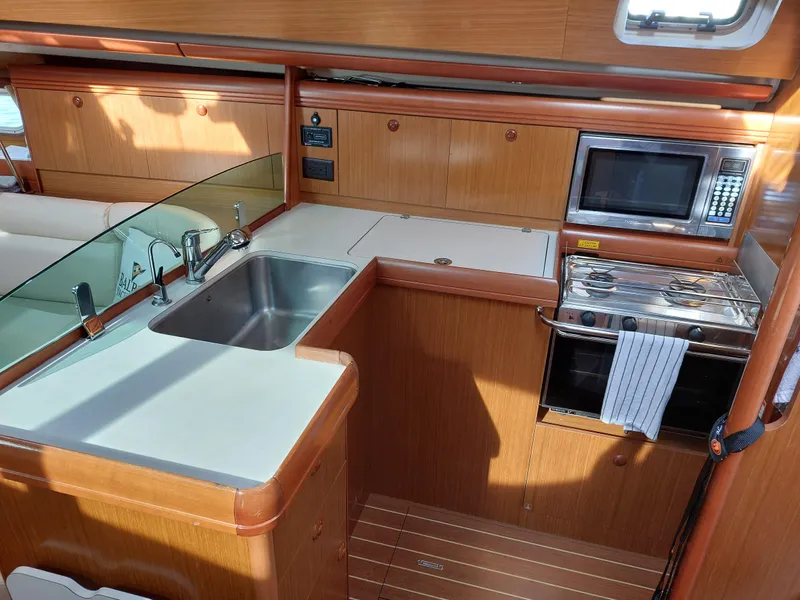 Slide: The Image of Interior of 2006 Jeanneau Sun Odyssey 42 DS yacht kitchen with sink, stove, and microwave. - 23