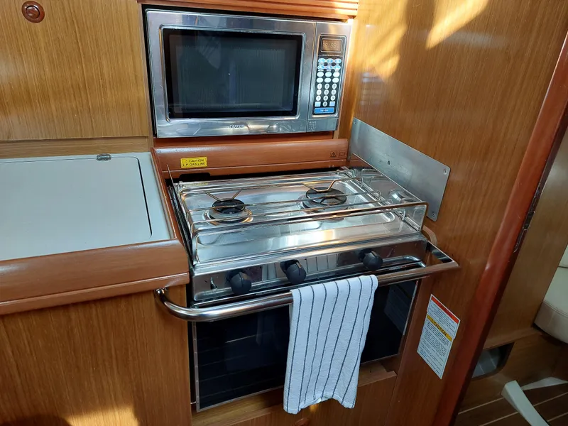 Slide: The Image of Galley kitchen in 2006 Jeanneau Sun Odyssey 42 DS with stove and microwave. - 24