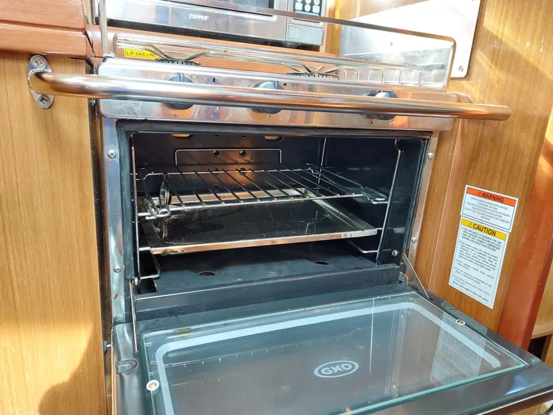 Slide: The Image of Oven inside 2006 Jeanneau Sun Odyssey 42 DS yacht, featuring stainless steel finish and open door. - 26