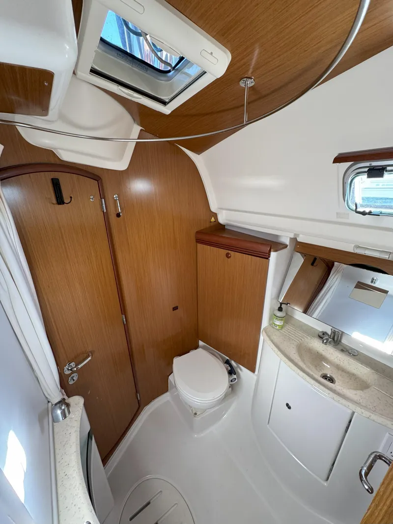 Slide: The Image of 2006 Jeanneau Sun Odyssey 42 DS bathroom with wood accents and skylight. - 29