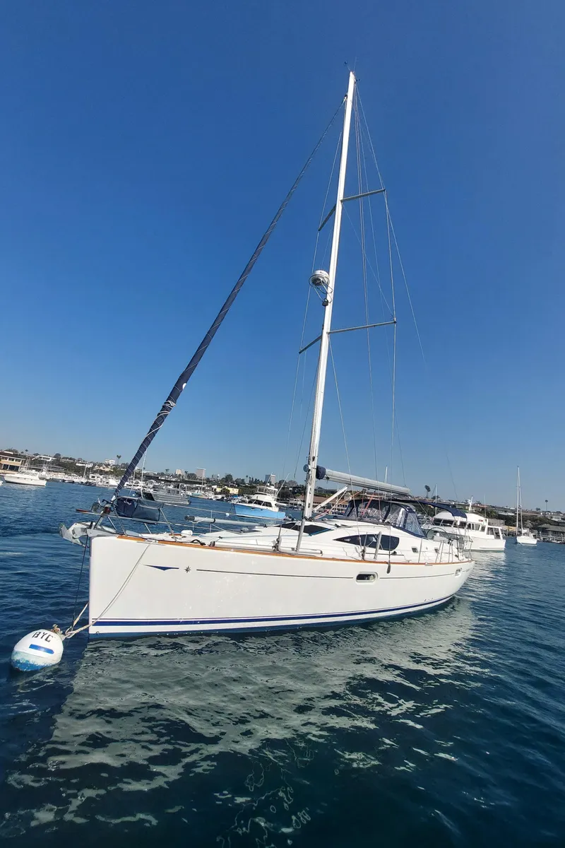 Slide: The Image of 2006 Jeanneau Sun Odyssey 42 DS sailboat on calm water under clear blue sky. - 3