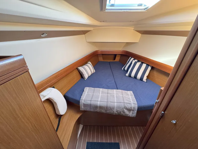 Slide: The Image of Cozy cabin interior of 2006 Jeanneau Sun Odyssey 42 DS sailboat with blue bedding. - 30