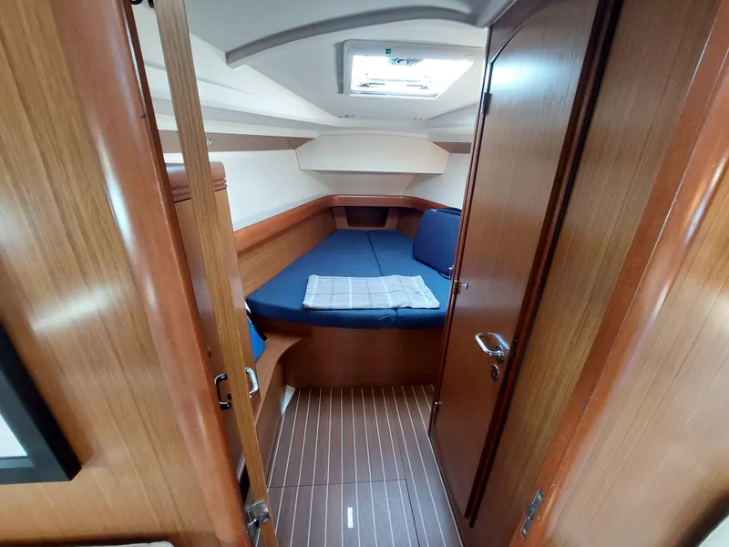 Slide: The Image of 2006 Jeanneau Sun Odyssey 42 DS cabin interior with wooden finish and blue bedding. - 34