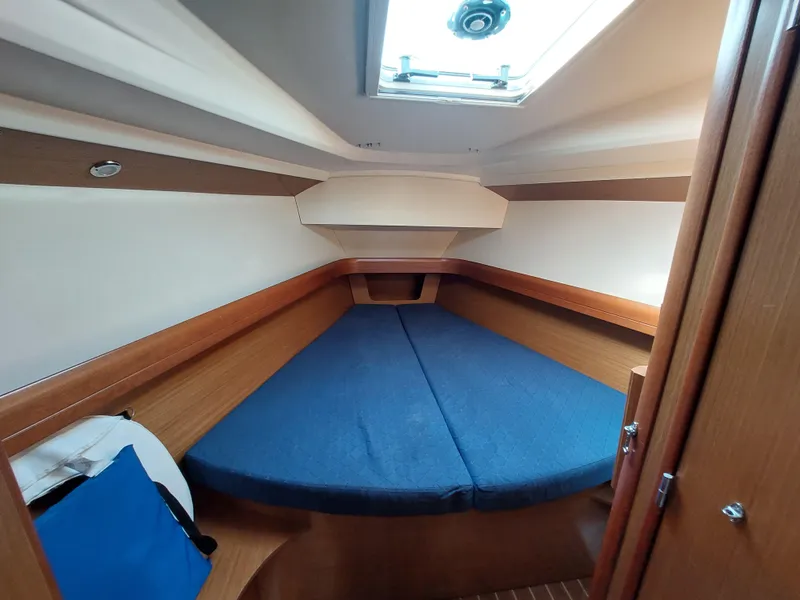 Slide: The Image of Interior cabin of 2006 Jeanneau Sun Odyssey 42 DS with blue bedding and wooden finish. - 37